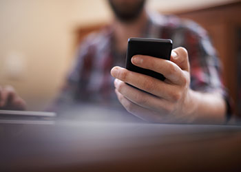 person using mobile phone for social media in classroom