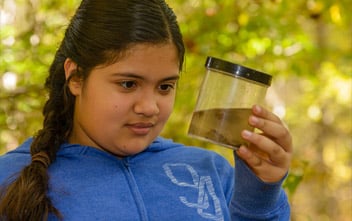 Girl holding jar