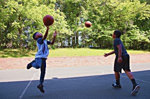 Two boys playing basketball